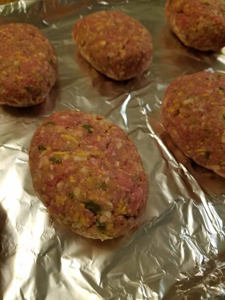 Miniature Pepper Jack Meatloaves on a foil lined baking sheet, ready to bake.