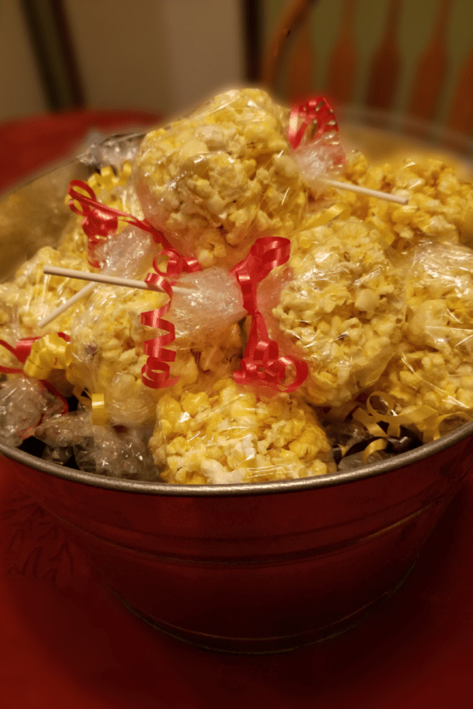 Bucket of wrapped popcorn balls.