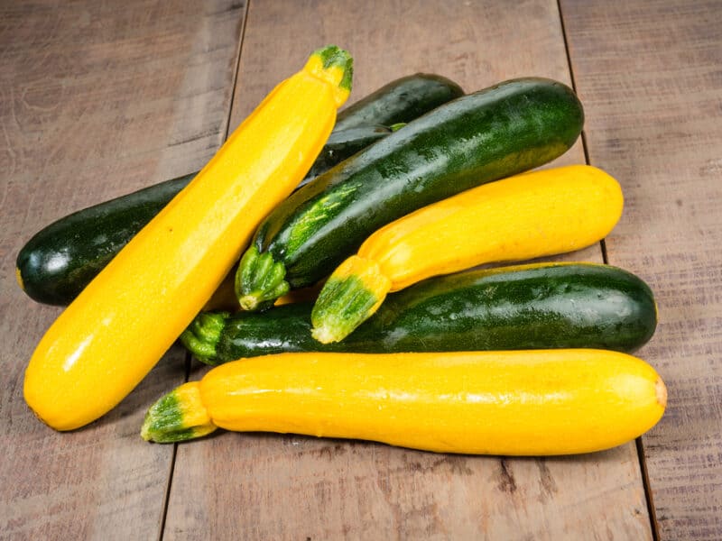 yellow squash and zucchini on a table.