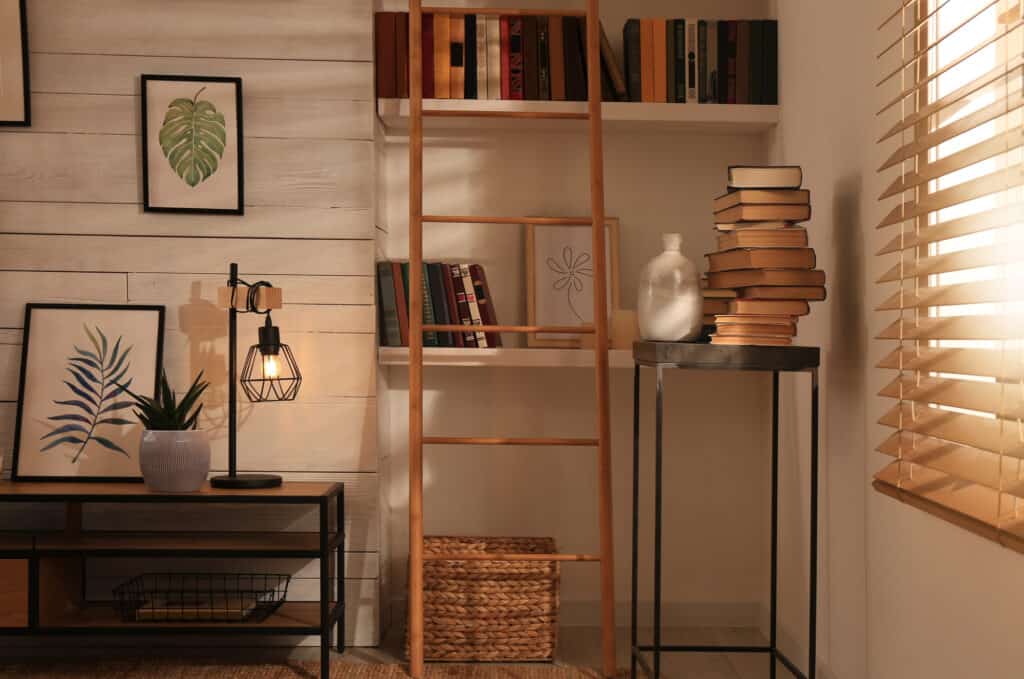 Home library interior with modern furniture and collection of different books on shelves