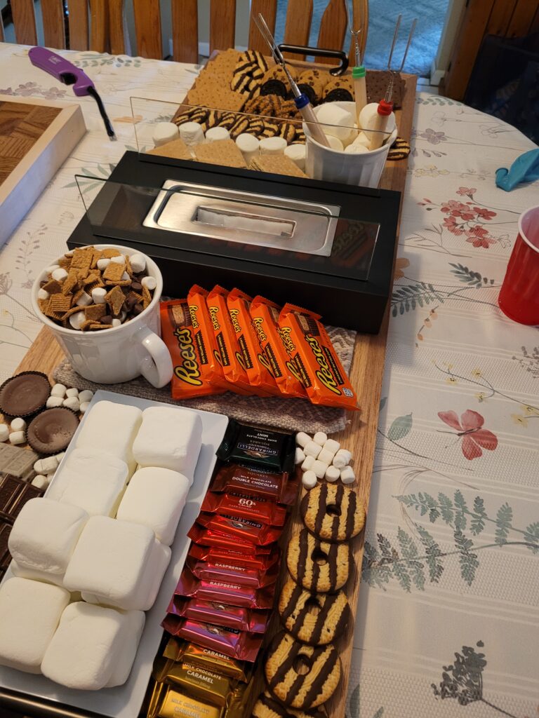 Tabletop fireplace on a s'mores board.